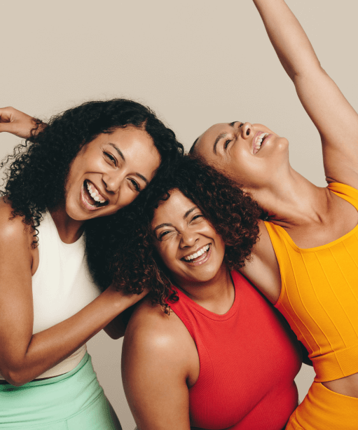 Three ladies wearing workout clothes feel happy
