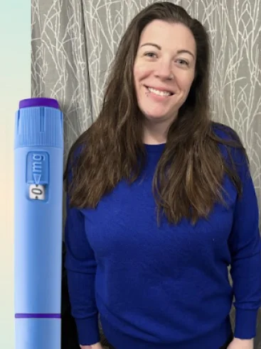 A woman smiling with blue weight loss pen